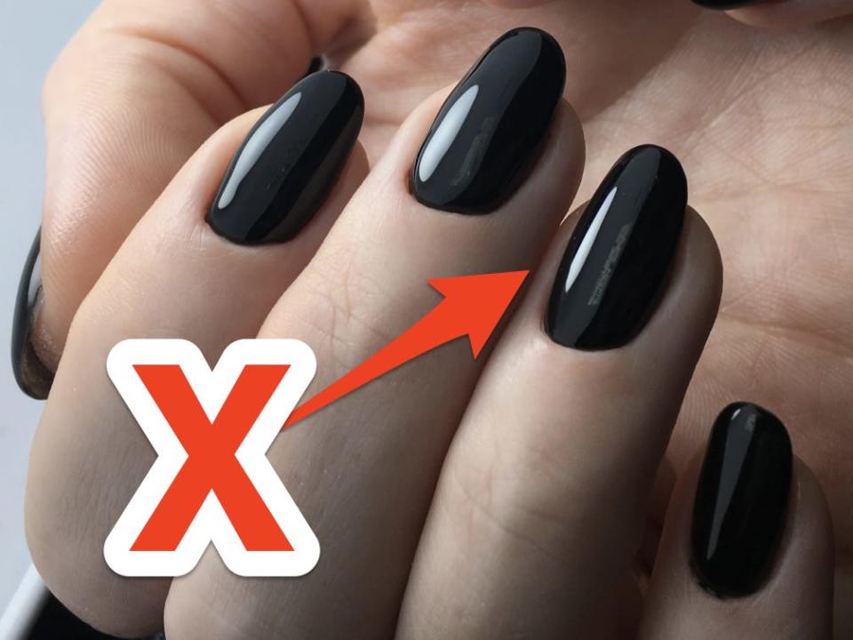 "x" over picture of black manicure.