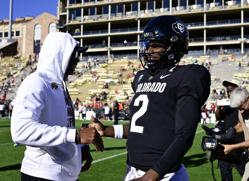 BOULDER, CO - SEPTEMBER 09: Colorado Buffaloes head coach Deion Sanders, left, greets his son Colorado Buffaloes quarterback Shedeur Sanders (2) before the game against the Nebraska Cornhuskers at Folsom Field September 09, 2023. (Photo by Andy Cross/MediaNews Group/The Denver Post via Getty Images)