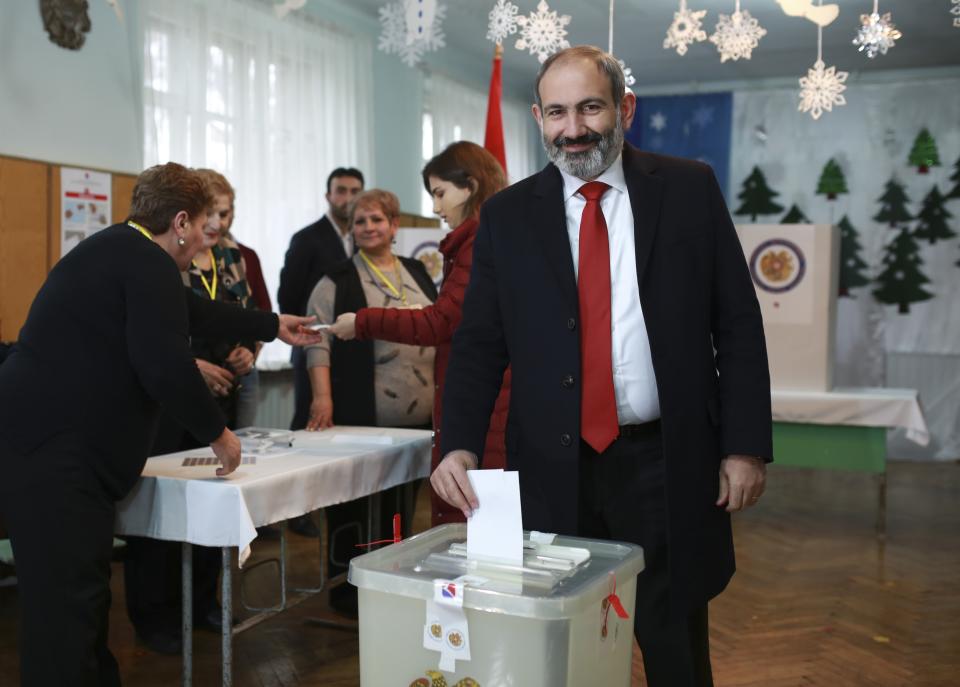 Acting Armenian Prime Minister Nikol Pashinian casts his ballot in a polling station during an early parliamentary election in Yerevan, Armenia, Sunday, Dec. 9, 2018. The charismatic 43-year-old Nikol Pashinian took office in May after spearheading massive protests against his predecessor's power grab that forced the politician to step down. (Vahan Stepanyan/PAN Photo via AP)