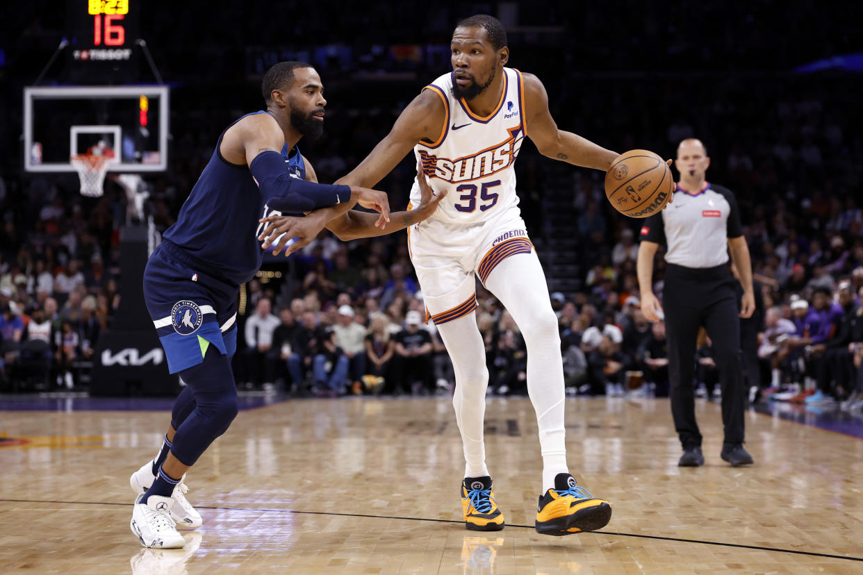 PHOENIX, ARIZONA - APRIL 05: Kevin Durant #35 of the Phoenix Suns posts up against Mike Conley #10 of the Minnesota Timberwolves during the first half at Footprint Center on April 05, 2024 in Phoenix, Arizona. NOTE TO USER: User expressly acknowledges and agrees that, by downloading and or using this photograph, User is consenting to the terms and conditions of the Getty Images License Agreement.  (Photo by Chris Coduto/Getty Images)