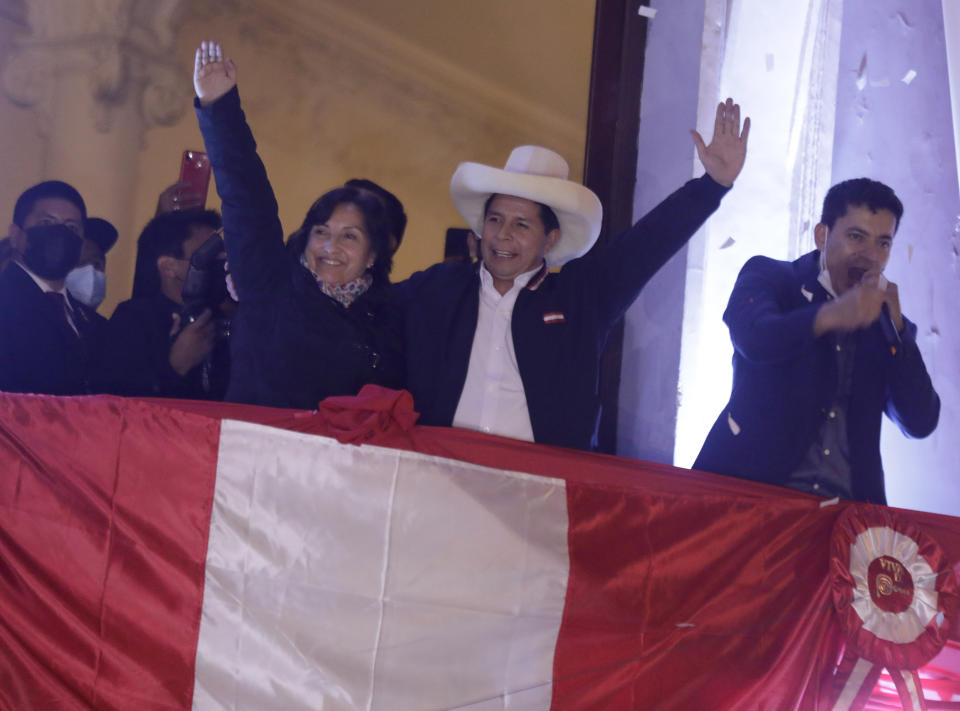 Pedro Castillo, center, celebrates with his running mate Dina Boluarte after being declared president-elect of Peru by election authorities, at his party´s campaign headquarters in Lima Peru, Monday, July 19, 2021. Castillo was declared president-elect more than a month after the elections took place and after opponent Keiko Fujimori claimed that the election was tainted by fraud. (AP Photo/Guadalupe Prado)