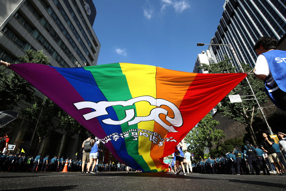 SEOUL, SOUTH KOREA - JULY 14: People wave a rainbow pride flag during the Korea Queer Culture Festival 2018 in front of City hall on July 14, 2018 in Seoul, South Korea. The annual festival promoting the LGBT rights had occasionally been disrupted by anti-LGBT groups in the past, though homosexuality is not illegal in the country. (Photo by Chung Sung-Jun/Getty Images)