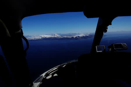 Deception Island, which is the caldera of an active volcano, is seen from inside the cockpit of a helicopter in Antarctica, February 18, 2018. REUTERS/Alexandre Meneghini