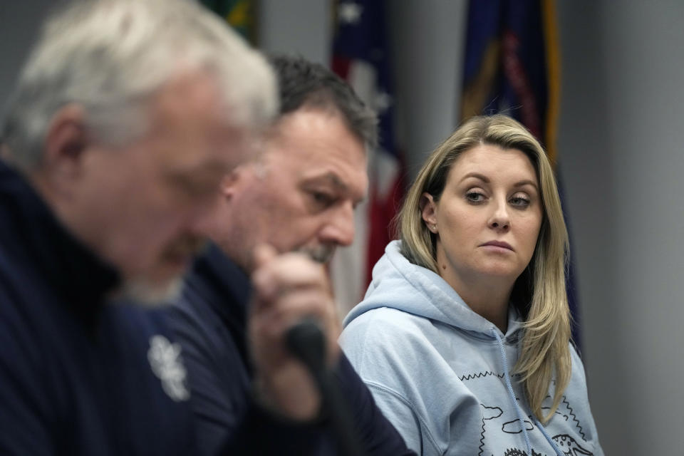 Nicole Beausoleil, right, the parent of Oxford H.S. School shooting victim Madisyn Baldwin looks towards Steve St. Juliana, left, and Buck Myre during an interview, Monday, March 18, 2024 in Pontiac, Mich. The parents of four students killed at a Michigan school called for a state investigation of all aspects of the 2021 mass shooting, saying a local criminal probe that netted three is not enough to close the book. (AP Photo/Carlos Osorio)