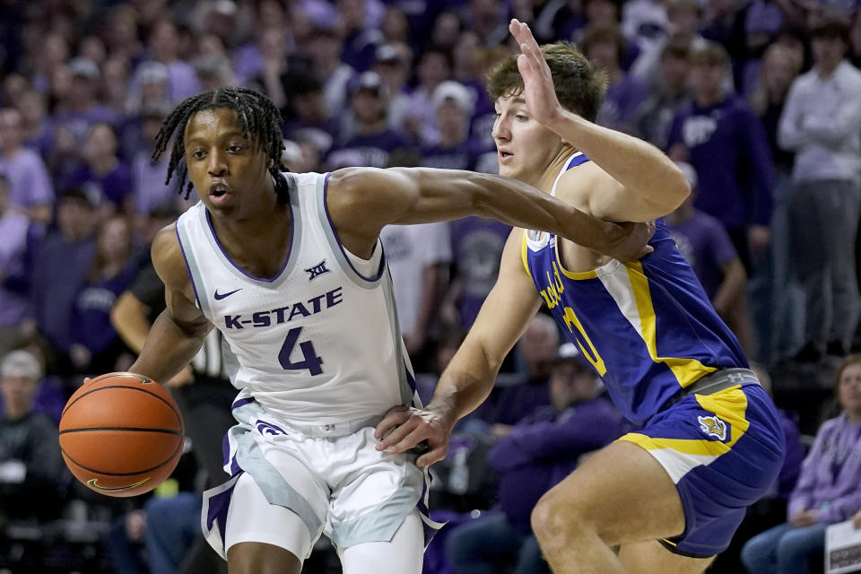 South Dakota State guard Kalen Garry, right, pressures Kansas State guard Darrin Ames (4) during the first half of an NCAA college basketball game Monday, Nov. 13, 2023, in Manhattan, Kan. (AP Photo/Charlie Riedel)