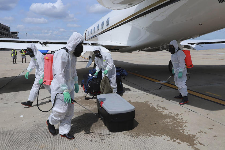 In this photo released by Royal Thai Army, health officers spray disinfectant on luggage belonging toU.S. Army Chief of Staff Gen. James McConville at Military airport in Bangkok, Thailand, Thursday, July 9, 2020. McConville will be the first official foreign guest to meet Thailand's Prime Minister Prayuth Chan-ocha at the Government House since travel restrictions were eased for a select group of foreigners allowed to visit Thailand. (Royal Thai Army via AP)