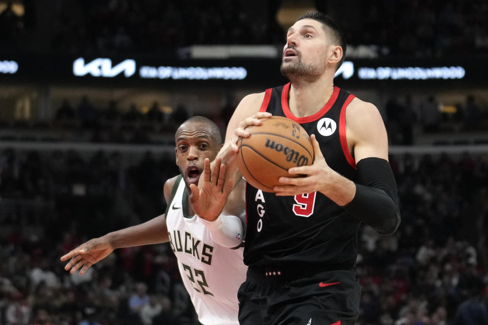 Chicago Bulls' Nikola Vucevic eyes the basket as Milwaukee Bucks' Khris Middleton defends during the first half of an NBA basketball game, Thursday, Nov. 30, 2023, in Chicago. (AP Photo/Charles Rex Arbogast)