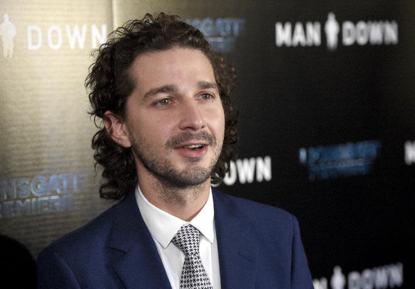 FILE - In this Nov. 30, 2016 file photo, Shia LaBeouf arrives at the Los Angeles premiere of "Man Down" at ArcLight Cinemas Hollywood. LaBeouf has been arrested early Thursday morning, Jan. 26, 2017, after he allegedly got into an altercation with another man outside a New York City museum. Police say LaBeouf pulled the scarf of an unidentified 25-year-old man early Thursday morning outside the Museum of the Moving Image in Queens, scratching his face in the process. (Photo by Chris Pizzello/Invision/AP, File)