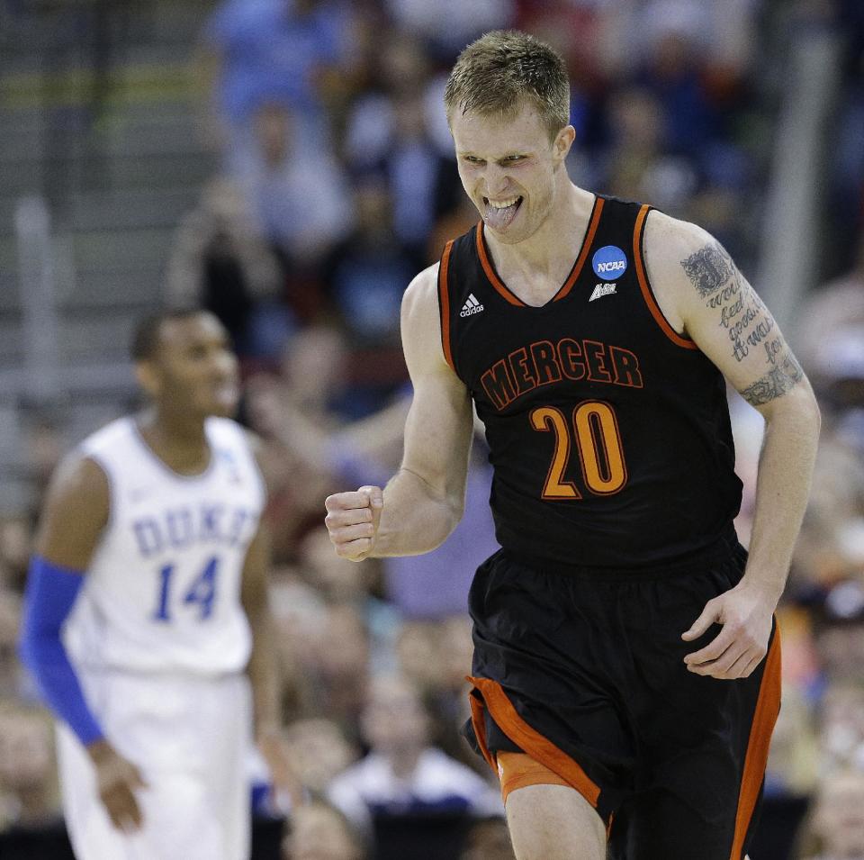 Mercer forward Jakob Gollon (20) celebrates a basket against Duke during the first half of a second-round game in the NCAA college basketball tournament, Friday, March 21, 2014, in Raleigh, N.C. (AP Photo/Gerry Broome)