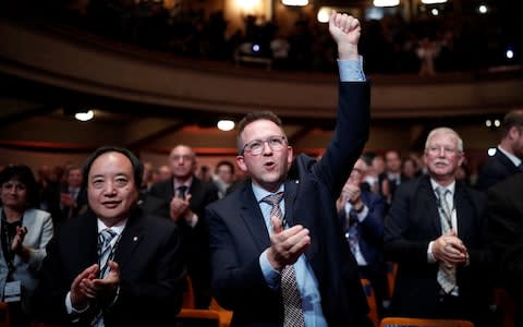 Scientists Yuning Duan and Gert Rietveld celebrate after the vote on the redefinition of four base units of the International System of Units - Credit: Reuters 