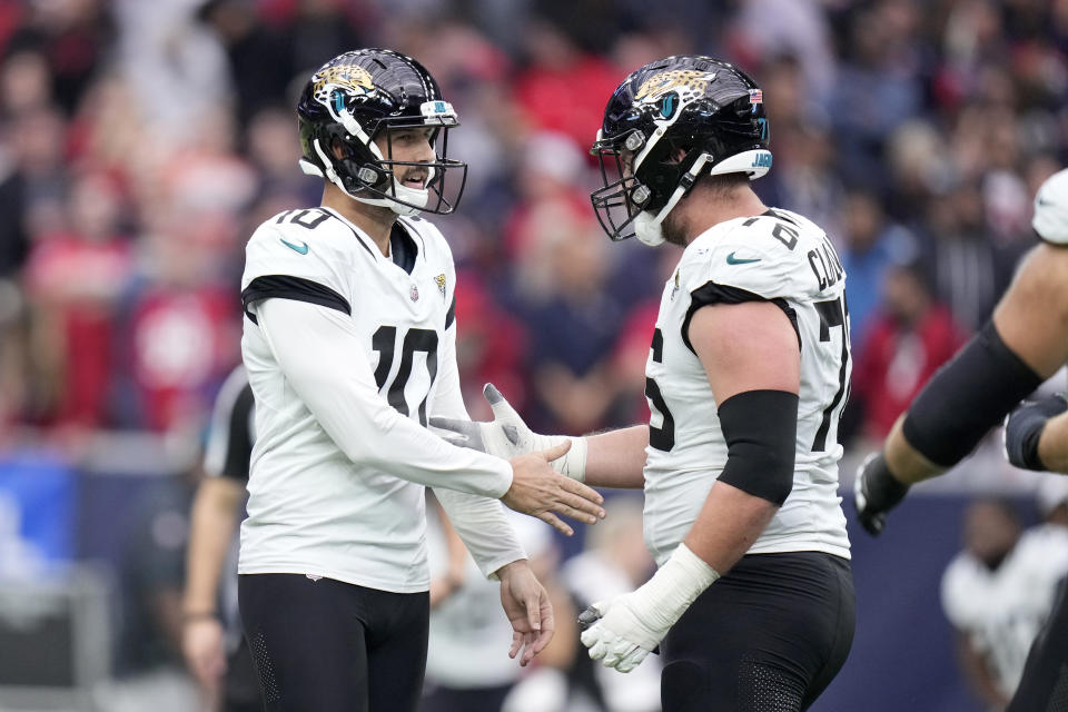 Jacksonville Jaguars place kicker Brandon McManus (10) and guard Ezra Cleveland (76) celebrate after McManus kicked a field goal in the second half of an NFL football game in Houston, Sunday, Nov. 26, 2023. (AP Photo/Eric Christian Smith)