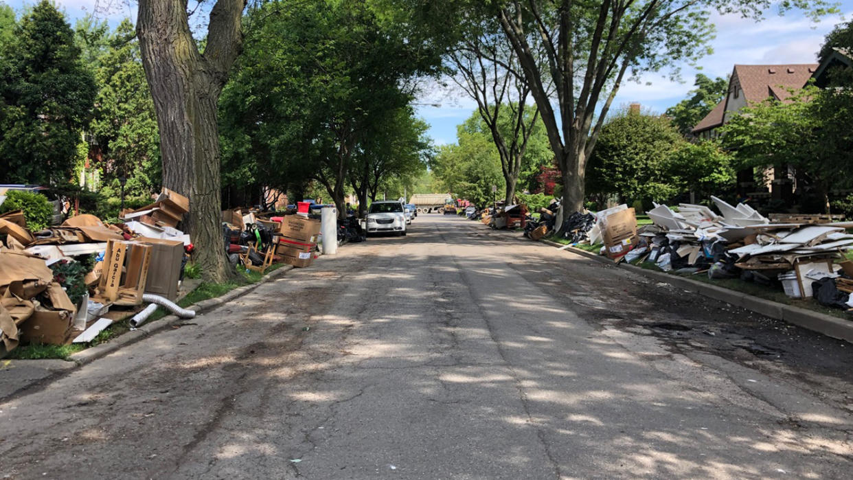 Residents in Grosse Pointe, Mich., try to clear out the damage on July 10, weeks after the first flooding. 