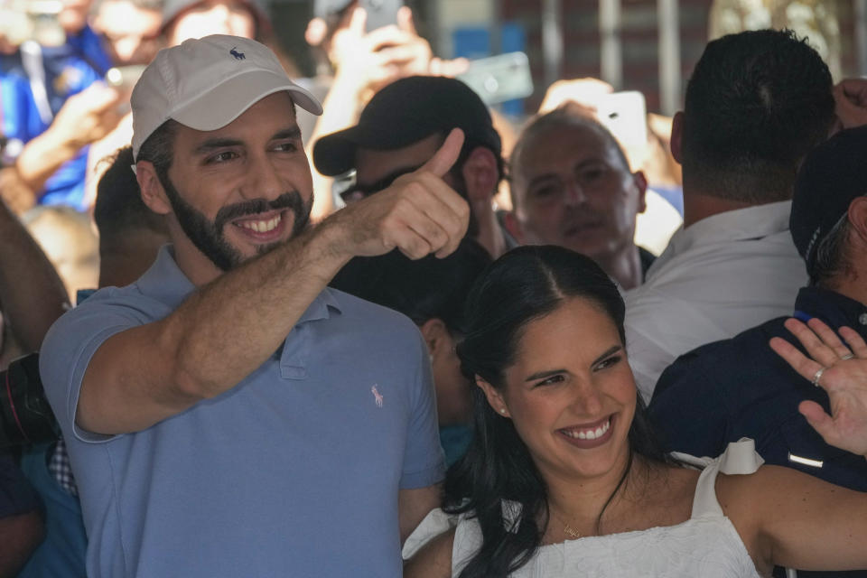 El Salvador President Nayib Bukele, who is seeking re-election, and his wife Gabriela Rodriguez wave after voting in the general election in San Salvador, El Salvador, Sunday, Feb. 4, 2024. (AP Photo/Moises Castillo)