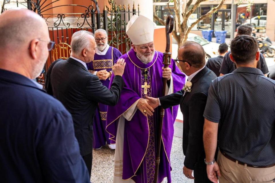 Archbishop Thomas Wenski meets with congregants following Ash Wednesday mass.