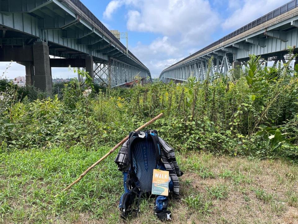 Stalls' backpack, book and walking stick are pictured on the east side of the Thames River heading west into New London, Conn., between the twin spans of the Gold Star Memorial Bridge.