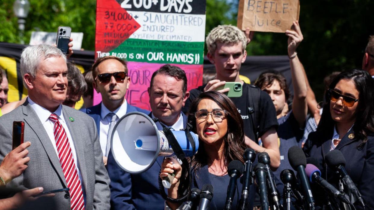 <div>Rep. Lauren Boebert (R-CO) uses a bullhorn to be heard over the crowd noise during a press conference at the George Washington University Gaza encampment, Washington, DC, May 1, 2024. Hundreds of students opposed to the far-right Republicans who visited the camp chanted over and frequently drowned out the members of Congress. GWU students established the camp the prior week in conjunction with students from other DC-area universities. It is one of more than one hundred Gaza solidarity encampments in college campuses across the country. (Photo by Allison Bailey / Middle East Images / Middle East Images via AFP) (Photo by ALLISON BAILEY/Middle East Images/AFP via Getty Images)</div>