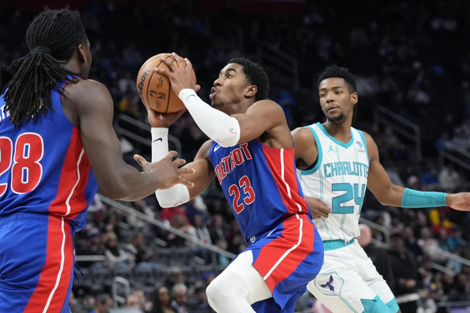 Detroit Pistons guard Jaden Ivey (23) attempts a layup as Charlotte Hornets forward Brandon Miller (24) defends during the second half of an NBA basketball game, Wednesday, Jan. 24, 2024, in Detroit. (AP Photo/Carlos Osorio)