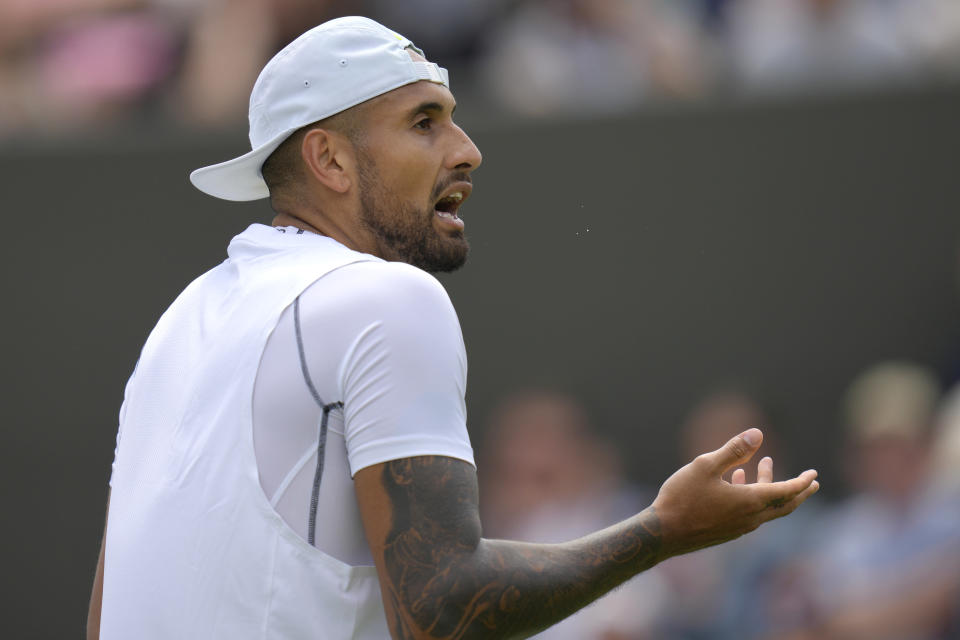 Australia's Nick Kyrgios complains about an umpire decision during the singles tennis match against Britain's Paul Jubb on day two of the Wimbledon tennis championships in London, Tuesday, June 28, 2022. (AP Photo/Kirsty Wigglesworth)