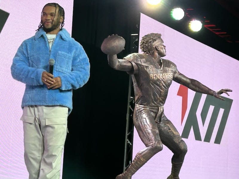 Former OU quarterback Kyler Murray stands next to a statue depicting him on Friday, April 21, at the Omni Hotel in Oklahoma City.