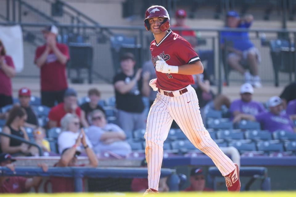 McCracken County's Jack Bennett (2) smiles up at the scoreboard on his way to home plate during the Collins vs. McCracken County KHSAA State Baseball Tournament game on Wednesday, June 16, 2021, at Lexington Legends Ballpark in Lexington, Kentucky. McCracken County won 13-2 in the fifth inning.