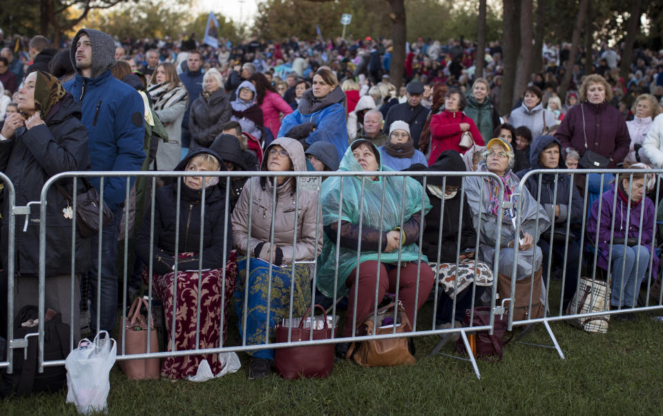 Faithful gather to follow Pope Francis' celebrating Holy Mass at the Confluence Park in Kaunas, Lithuania, Sunday, Sept. 23, 2018. Pope Francis is on the second of his two-day visit to Lithuania. (AP Photo/Mindaugas Kulbis)