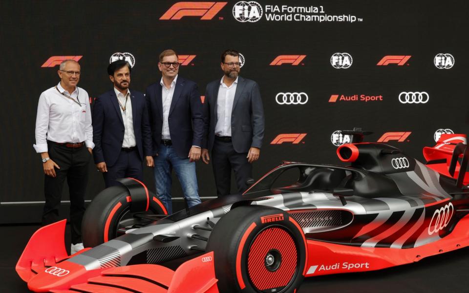 From left, President and CEO of Formula One Stefano Domenicali, FIA President Mohammed Ben Sulayem, CEO of Audi Markus Duesmann, Audi's Chief Development Officer Oliver Hoffman pose in front of the new Audi F1 car during a media conference ahead of the Formula One Grand Prix at the Spa-Francorchamps racetrack in Spa, Belgium, Friday - AP