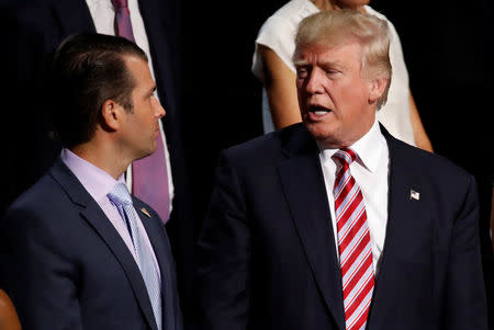 FILE PHOTO: Donald Trump Jr. (L) talks with his father, Republican Presidential candidate Donald Trump during the 2016 Republican National Convention in Cleveland, Ohio U.S. July 20, 2016. REUTERS/Jim Young/File photo