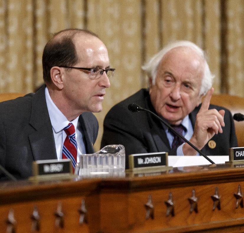 House Ways and Means Committee Chairman Rep. Dave Camp , R-Mich., left, and the committee's ranking member, Rep. Sander Levin, D-Mich., exchange words on Capitol hill in Washington, Wednesday, April 9, 2014, during a disagreement over procedure as the panel debates whether IRS official Lois Lerner’s refusal to testify to Congress deserves criminal prosecution. After Rep. Levin’s insistence that he, the top Democrat, be heard, Chairman Camp told Levin to “chill out.” Levin replied that he was “very chilled out.” Ways and Means wants the Justice Department to open a criminal probe against Lerner. (AP Photo/J. Scott Applewhite)