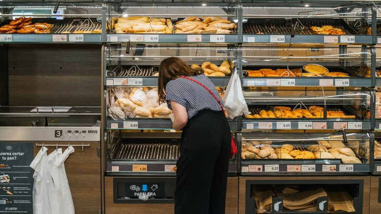 person picking bread from Aldi bakery