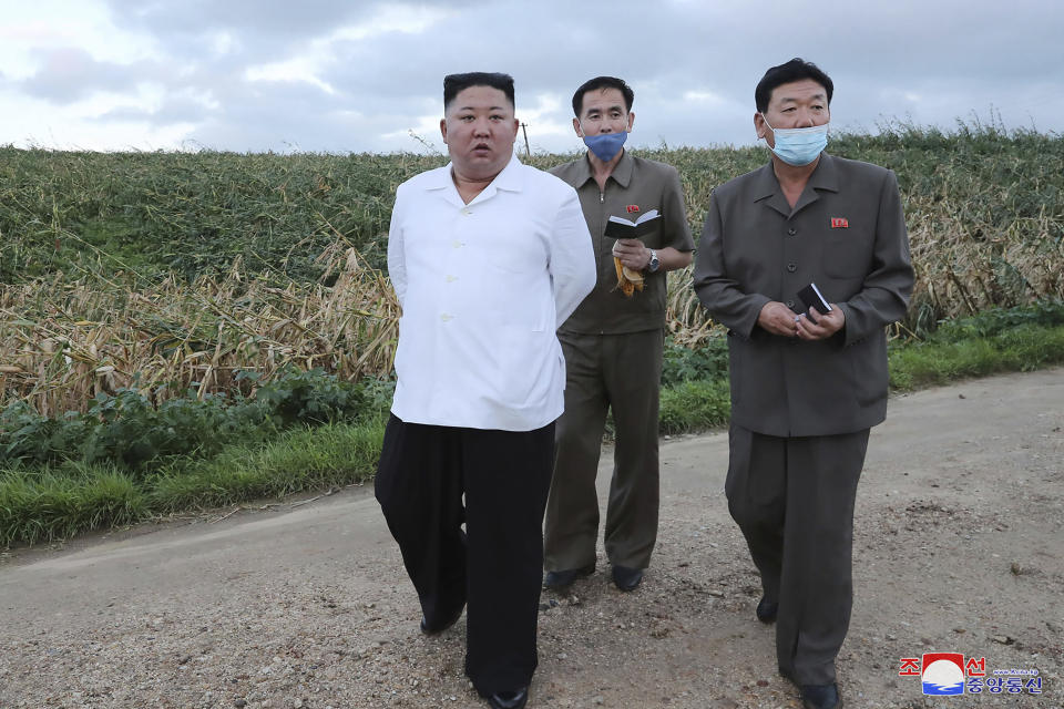 In this undated photo provided on Friday, Aug. 28, 2020, by the North Korean government, North Korean leader Kim Jong Un, left, visits a western coastal area in South Hwanghae province, North Korea, where Typhoon Bavi made landfall early Thursday, Aug. 27. Independent journalists were not given access to cover the event depicted in this image distributed by the North Korean government. The content of this image is as provided and cannot be independently verified. Korean language watermark on image as provided by source reads: "KCNA" which is the abbreviation for Korean Central News Agency. (Korean Central News Agency/Korea News Service via AP)