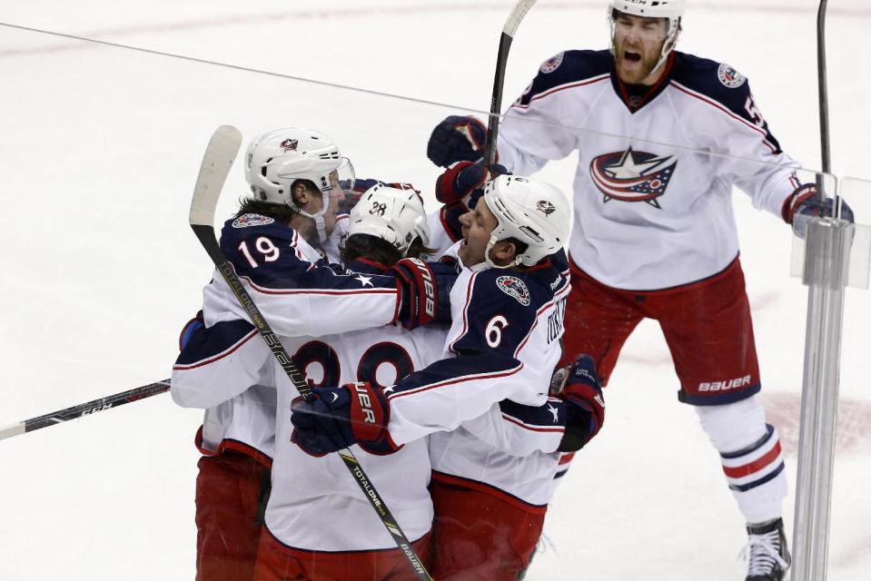 Columbus Blue Jackets' Boone Jenner (38) celebrates his goal with teammates in the first period of Game 5 of a first-round NHL playoff hockey series against the Pittsburgh Penguins in Pittsburgh, Saturday, April 26, 2014. (AP Photo/Gene J. Puskar)