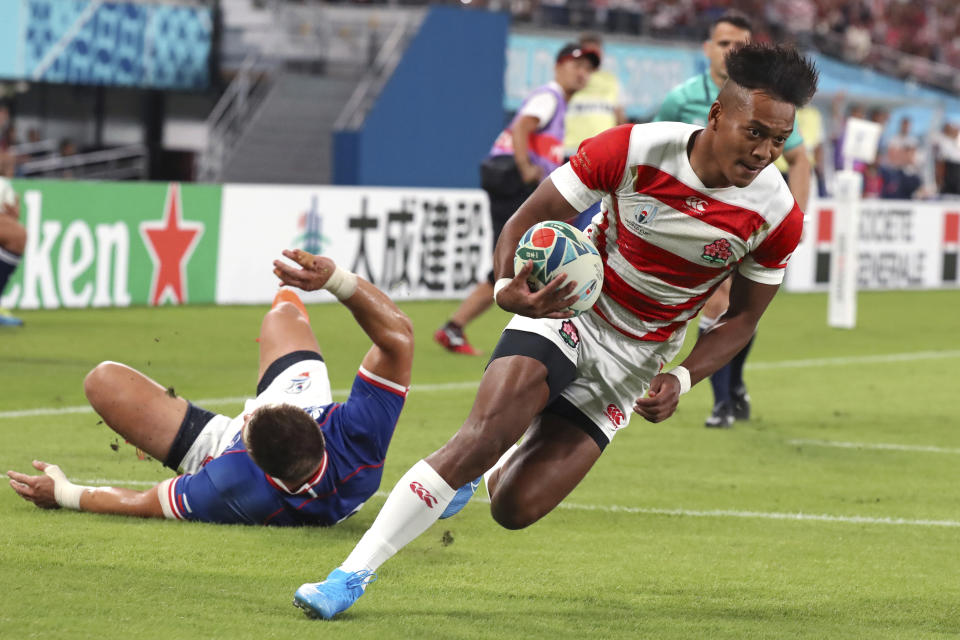 Japan's Kotaro Matsushima runs to scoring a try during the Rugby World Cup Pool A game at Tokyo Stadium between Russia and Japan in Tokyo, Japan, Friday, Sept. 20, 2019. (AP Photo/Eugene Hoshiko)