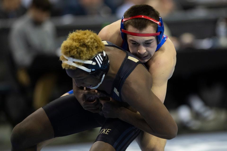 Christian Arberry of Warren Central and Branson Weaver of Owen Valley compete in the 144-pound quarterfinal round of the 2023-24 IHSAA State Wrestling tournament at Ford Center in Evansville, Ind., Saturday, Feb. 17, 2024.