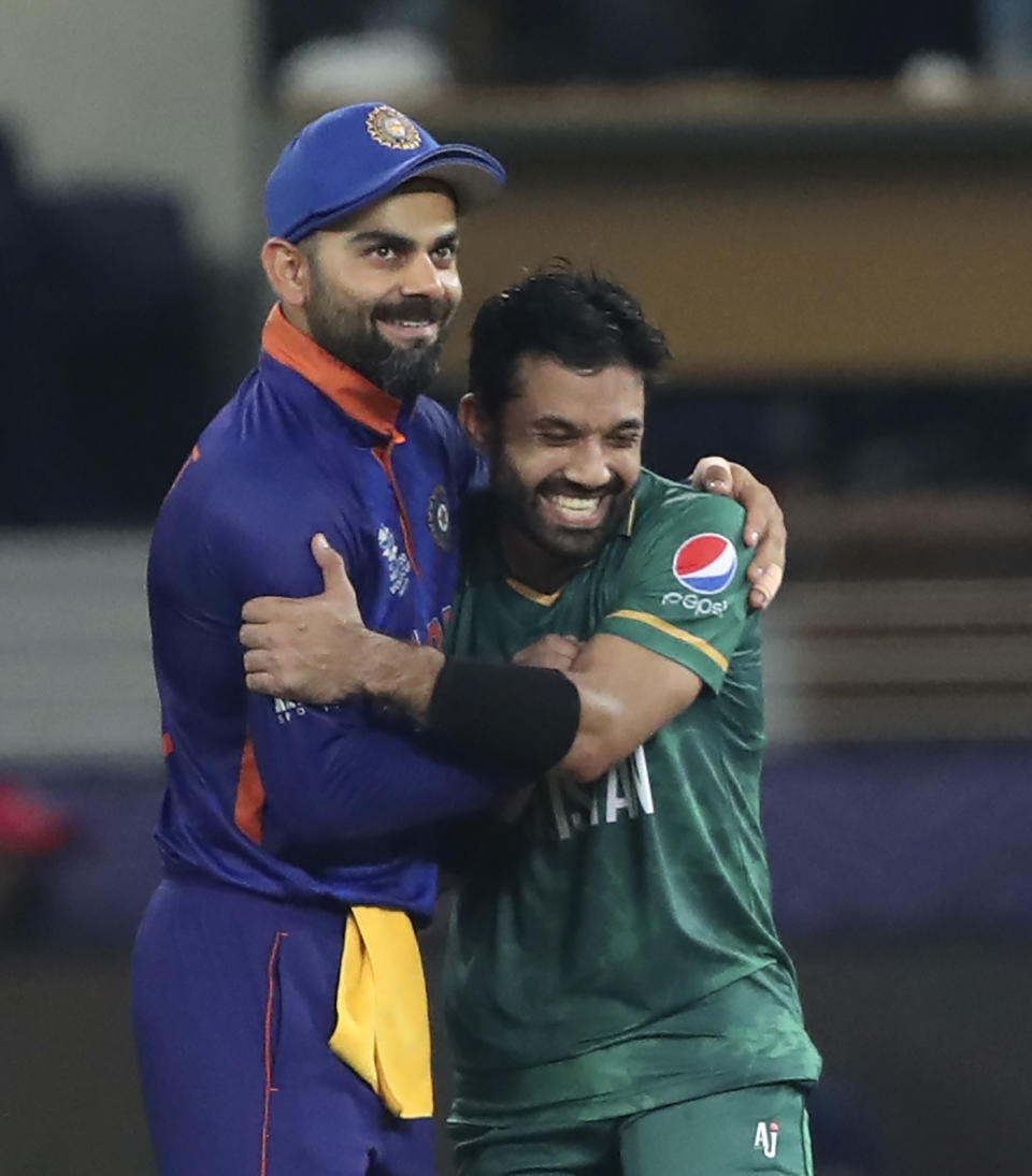 Indian cricket captain Virat Kohli congratulates Pakistan's Mohammad Rizwan after Pakistan won the Cricket Twenty20 World Cup match between India and Pakistan in Dubai, UAE, Sunday, Oct. 24, 2021. (AP Photo/Aijaz Rahi)