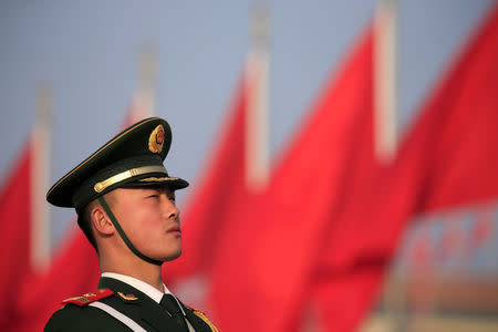 A paramilitary police officer stands guard outside the Great Hall of the People ahead of National People's Congress (NPC), China's annual session of parliament, in Beijing, China March 4, 2019. REUTERS/Aly Song