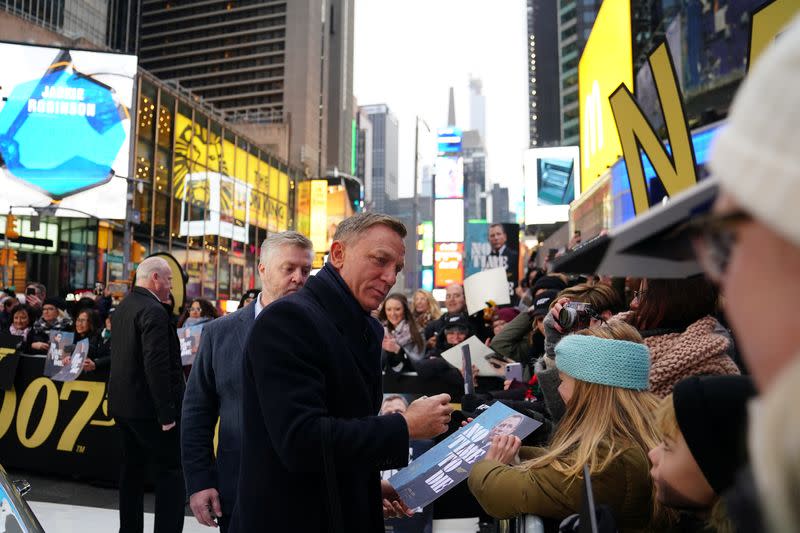 Actor Daniel Craig signs autographs during a promotional appearance on TV in Times Square for the new James Bond movie "No Time to Die" in the Manhattan borough of New York City