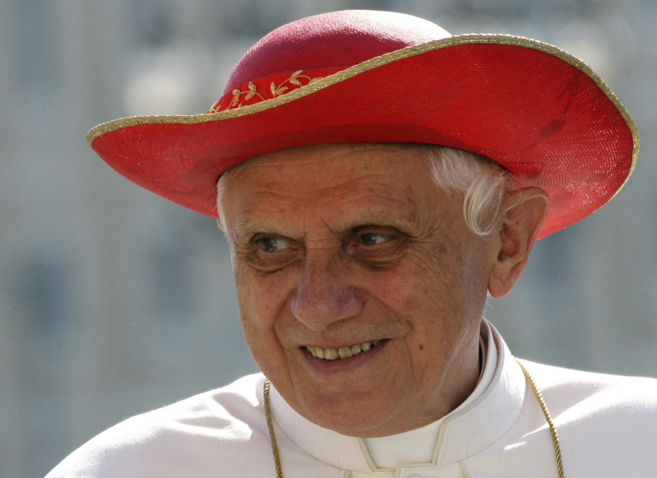 FILE - Pope Benedict XVI wears a "saturno hat", inspired by the ringed planet Saturn, to shield himself from the sun as he is driven through the crowd of faithful prior to his weekly general audience in St. Peter's Square at the Vatican, on Sept. 6, 2006. He was the reluctant pope, a shy bookworm who preferred solitary walks in the Alps and Mozart piano concertos to the public glare and majesty of Vatican pageantry. When Cardinal Joseph Ratzinger became Pope Benedict XVI and was thrust into the footsteps of his beloved and charismatic predecessor, he said he felt a guillotine had come down on him. The Vatican announced Saturday Dec. 31, 2022 that Benedict, the former Joseph Ratzinger, had died at age 95. (AP Photo/Pier Paolo Cito, File)