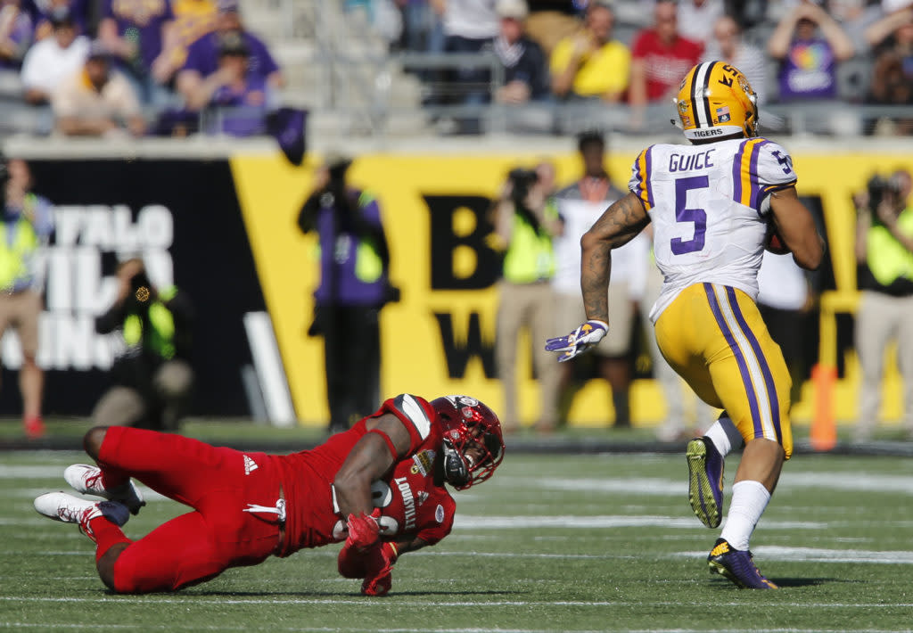 Dec 31, 2016; Orlando, FL, USA; LSU Tigers running back Derrius Guice (5) runs past Louisville Cardinals cornerback Ronald Walker (20) on his way for a touchdown during the second half of an NCAA football game in the Buffalo Wild Wings Citrus Bowl at Camping World Stadium. The Tigers won 29-9. Mandatory Credit: Reinhold Matay-USA TODAY Sports