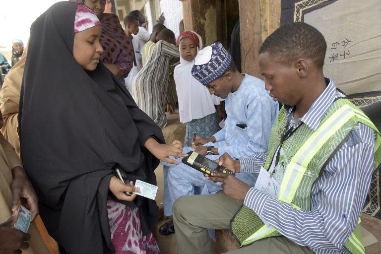 A woman is accredited to vote by a biometric system on March 28, 2015 outside a polling station in Gidan Niyam Sakin Yara in Daura in Katsina State