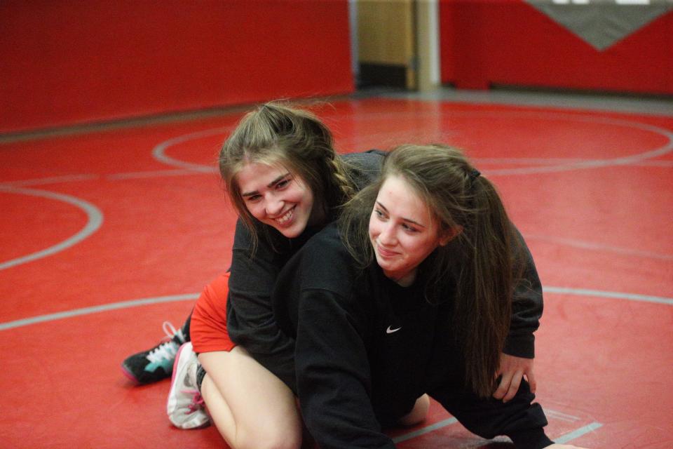West Lafayette sisters Rose (top) and Isabel Kaplan (right) share a spontaneous moment of hilarity during practice on Wednesday, Jan. 3, 2024.