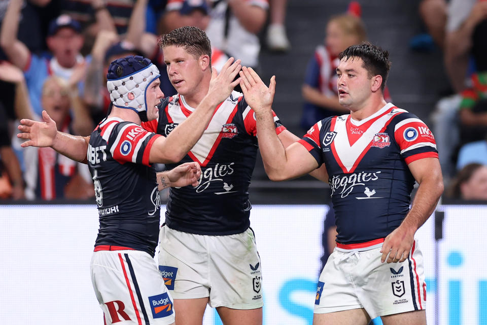 Pictured far right, Brandon Smith celebrates with Roosters teammates after scoring a try against South Sydney. 