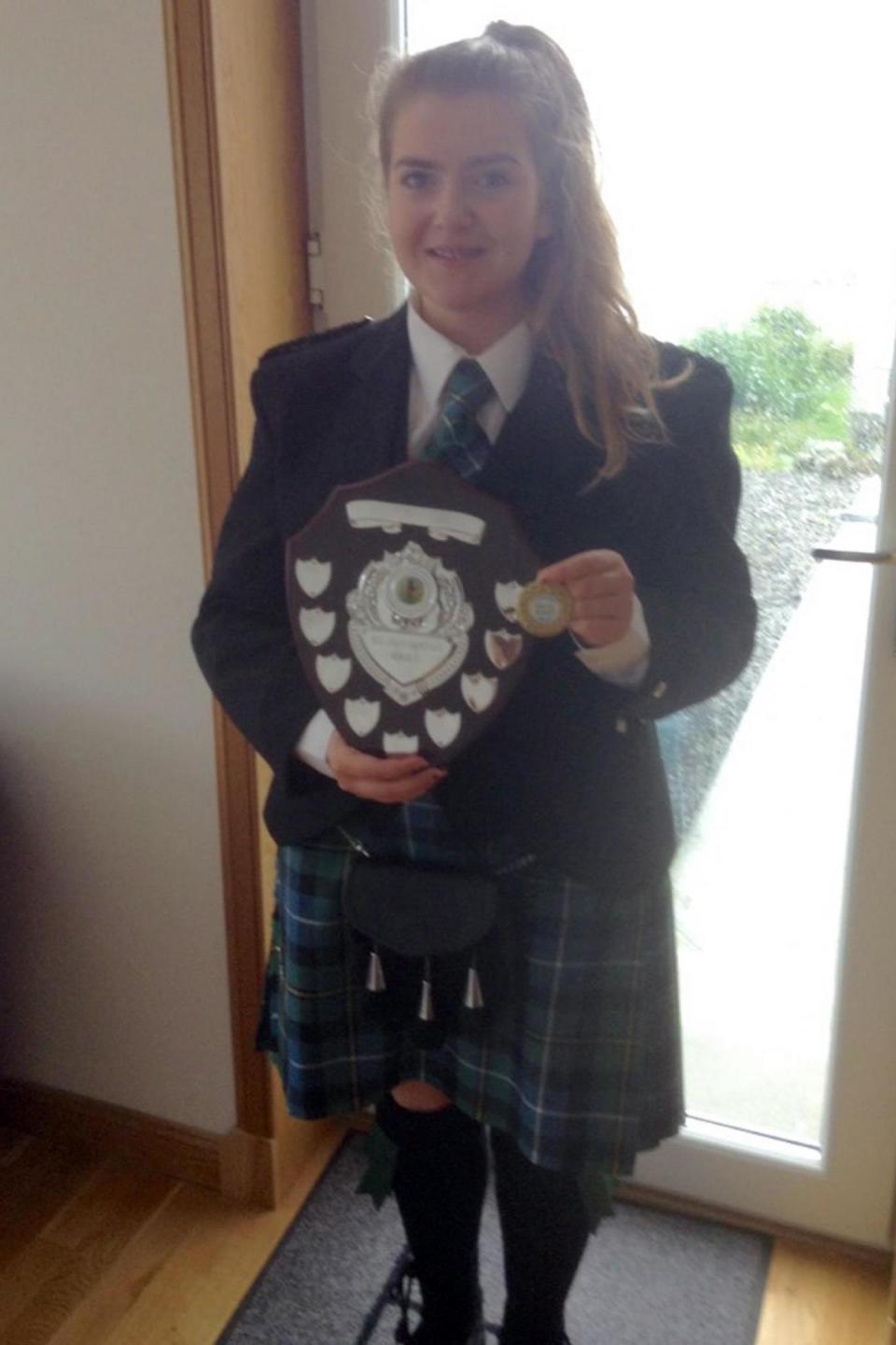 Proud: Eilidh posing with a bagpiping award (PA)