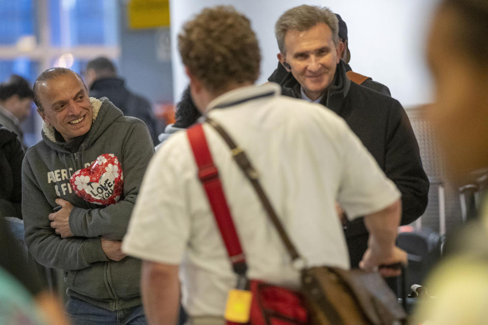 In this Tuesday, Dec. 3, 2019, photo Mohammed Hafar holds a gift he bought while waiting for his daughter Jana Hafar to clear customs and immigration at JFK Airport in New York. Mohammed Hafar was part of a federal lawsuit filed in August of this year over the travel ban waiver process. “Every time I speak to her, she ask, ‘When are they going to give me the visa?'" the elder Hafar said, recalling the days of uncertainty that took up the better part of this year. There was “nothing I could tell her, because nobody knows when." (AP Photo/Mary Altaffer)