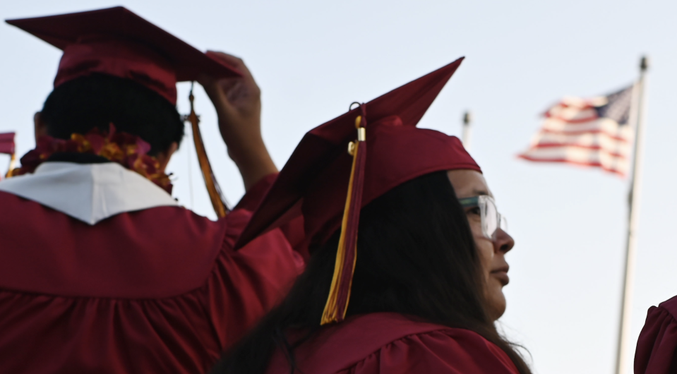 A US flag flies above a building as students earning degrees at Pasadena City College participate in the graduation ceremony, June 14, 2019, in Pasadena, California. (Photo: ROBYN BECK/AFP via Getty Images)