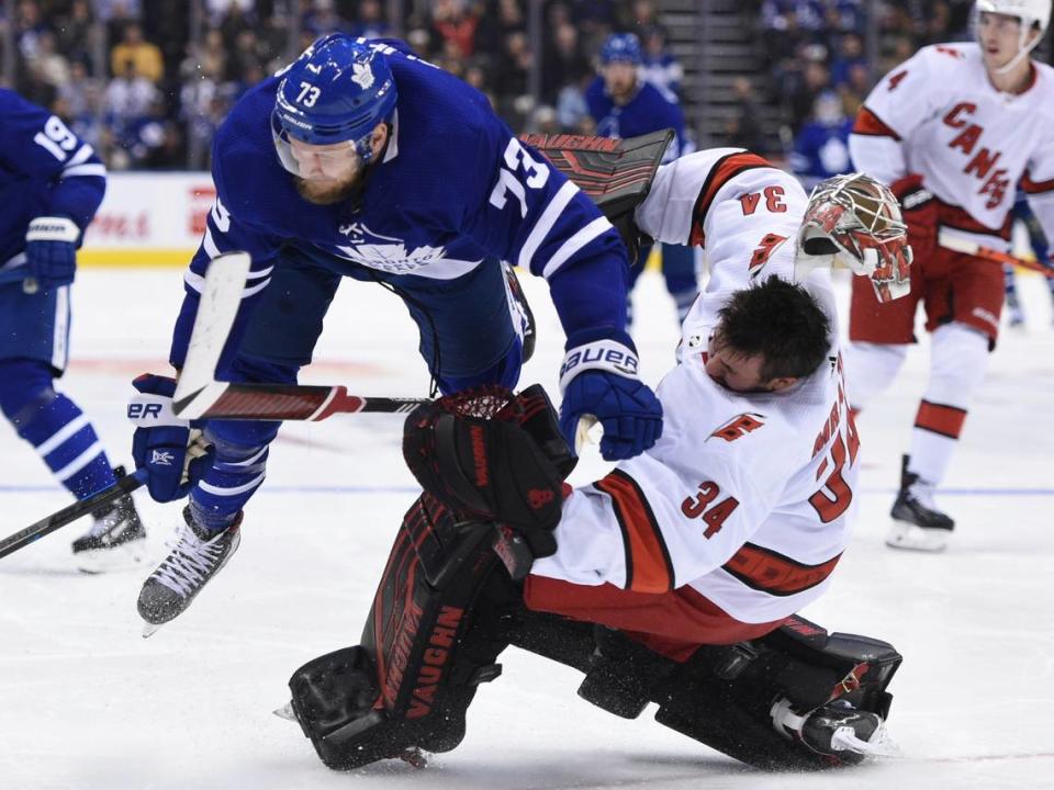 Carolina Hurricanes goaltender Petr Mrazek (34) hits the ice after Toronto Maple Leafs left wing Kyle Clifford (73) skated into him during second-period NHL hockey game action in Toronto, Saturday, Feb. 22, 2020. (Frank Gunn/The Canadian Press via AP)