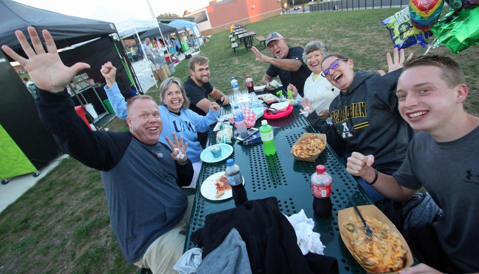 Brian Hunnell, Sherry Gant, Caleb Gant, Jim Gant, Ginny Hunnell, Jennenne Hunnell and Ian Hunnell grab a bite to eat prior to the start of the Gastonia Honey Hunters game against the Dirty Birds of Charleston Saturday evening at CaroMont Health Park.