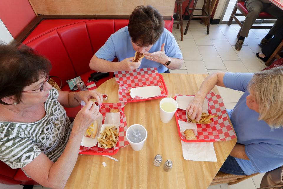 Friends Lynda Dennis, Kim Harrington and Rhonda Taylor enjoy Dog Et Al, a favorite spot of theirs to reunite, for lunch Monday, April 15, 2019. 