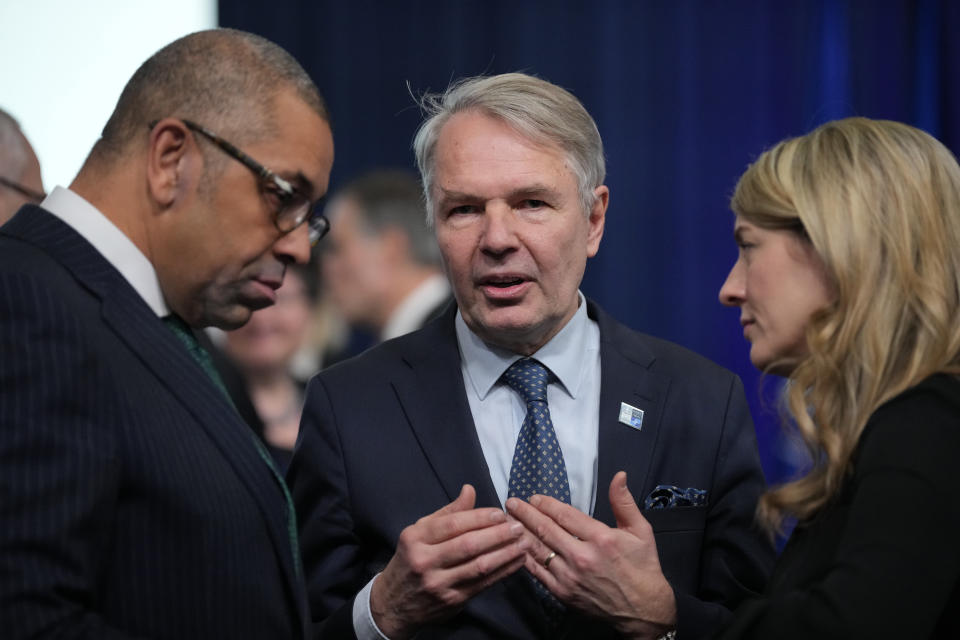 Britain's Foreign Secretary James Cleverly, left, talks with Finland's Foreign Minister Pekka Haavisto, center, and Canada's Foreign Minister Melanie Joly during the first day of the meeting of NATO Ministers of Foreign Affairs, in Bucharest, Romania, Tuesday, Nov. 29, 2022. (AP Photo/Andreea Alexandru)