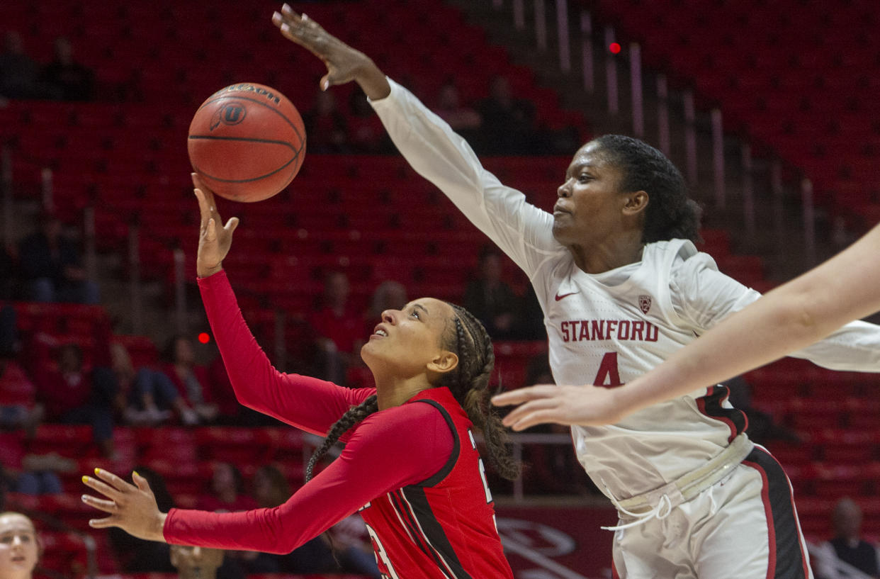 Utah guard Daneesha Provo (23) takes the ball to the basket as Stanford forward Nadia Fingall (4) defends during an NCAA college basketball game Friday, Feb. 14, 2020, in Salt Lake City. (Rick Egan/The Salt Lake Tribune via AP)