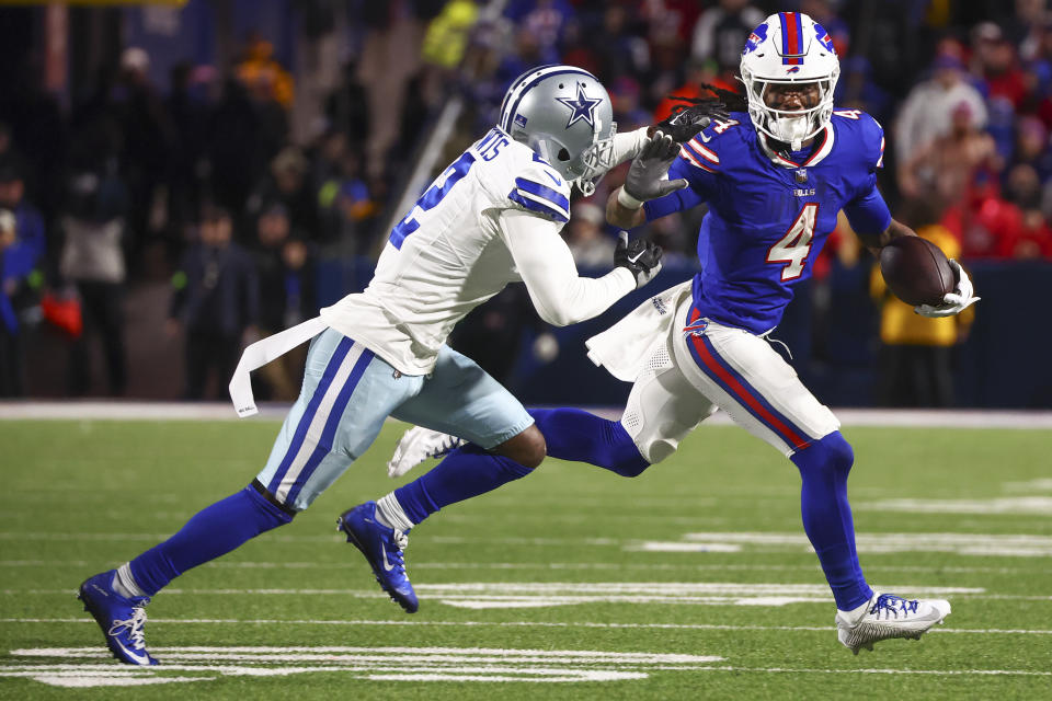 Buffalo Bills running back James Cook (4) carrie the ball against Dallas Cowboys cornerback Jourdan Lewis (2) during the second quarter of an NFL football game, Sunday, Dec. 17, 2023, in Orchard Park, N.Y. (AP Photo/Jeffrey T. Barnes)